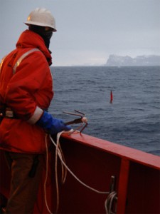 Ross Hein prepares to snag the floating whalebone lander (red flag) with a grappling hook.